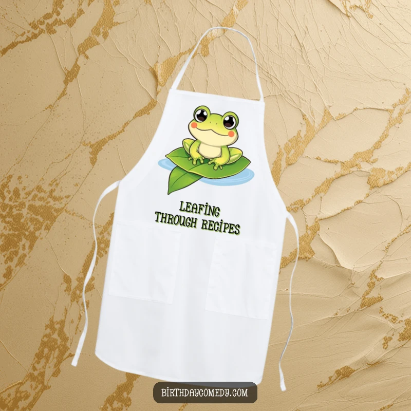 Funny frog apron showing a content frog with bulging eyes floating on a large leaf, perfect for kitchen humor.