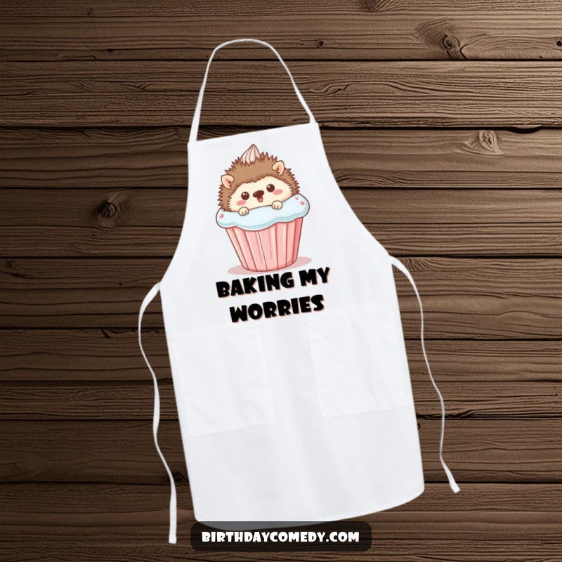 Funny Apron showcasing a happy hedgehog peeking from behind a large cupcake, designed for kitchen protection with a cute and humorous appeal.