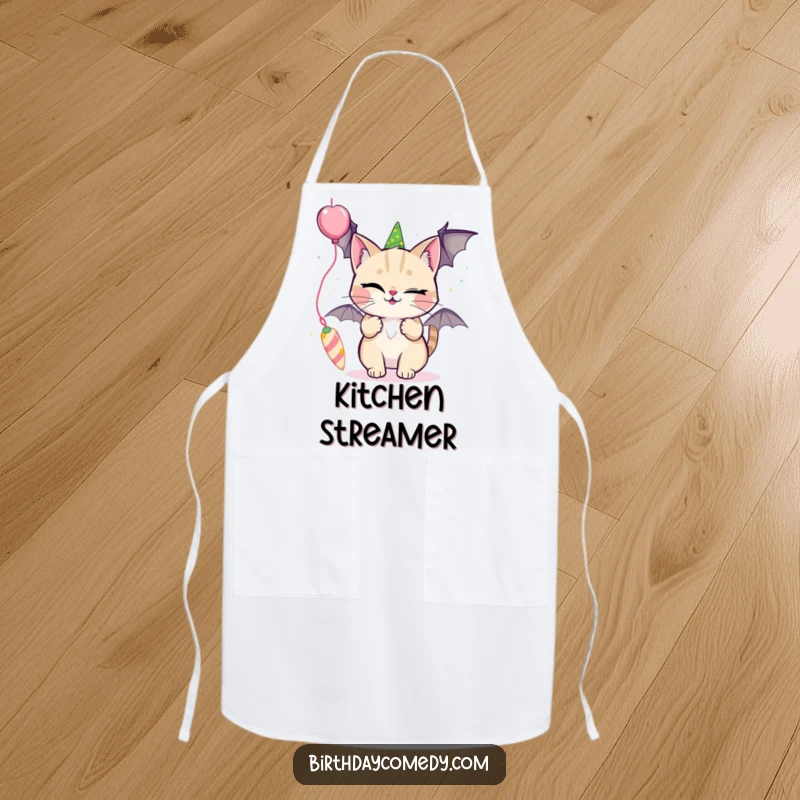 Funny apron with a winking cat playfully batting at a dangling party streamer, great for kitchen fun.