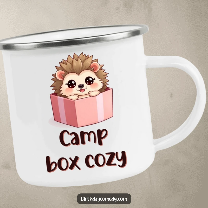 Funny hedgehog camping mug, a happy character rolling inside a present box, perfect for outdoor enjoyment.