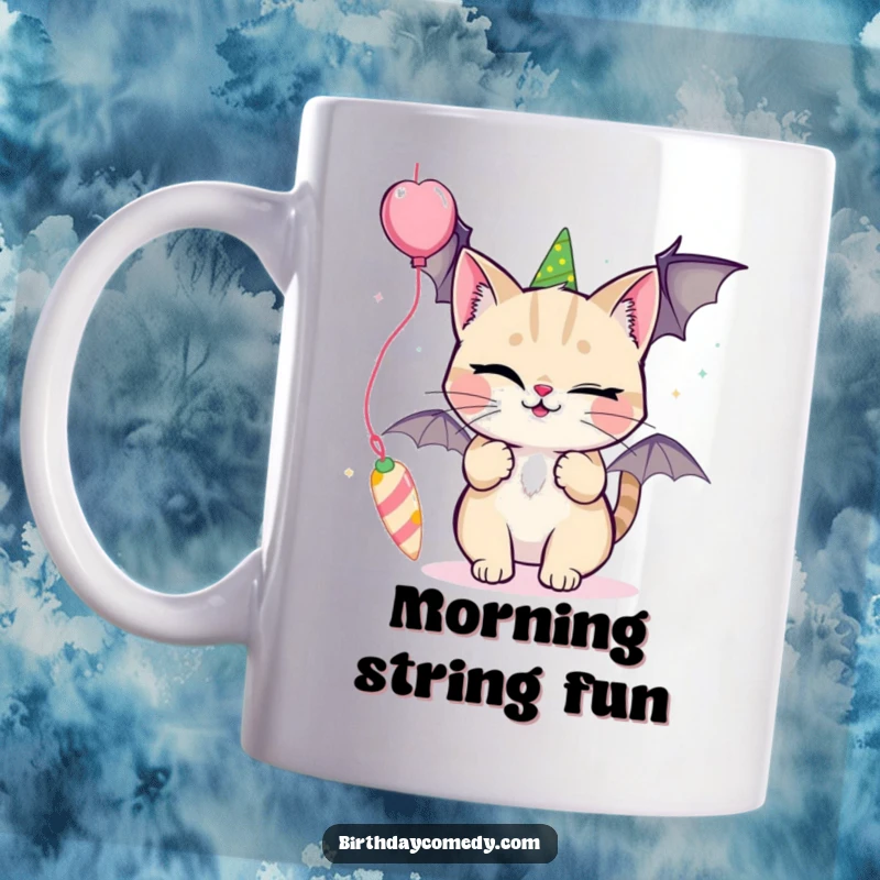 Funny mug featuring a winking cat playfully batting at a colorful, dangling party streamer.
