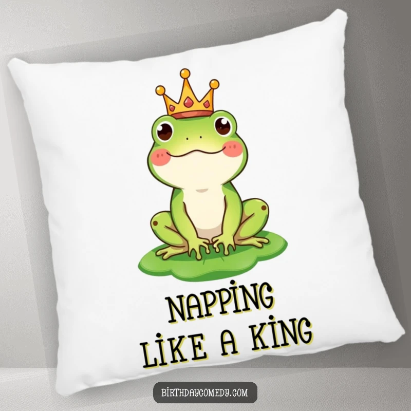 Funny pillow showcasing a happy frog character wearing a tiny crown and balancing a lily pad as a hat, perfect for cozying up.