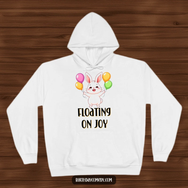 Funny hoodie with a fluffy bunny character juggling colorful balloons with a wide, happy smile, perfect for spreading joy.