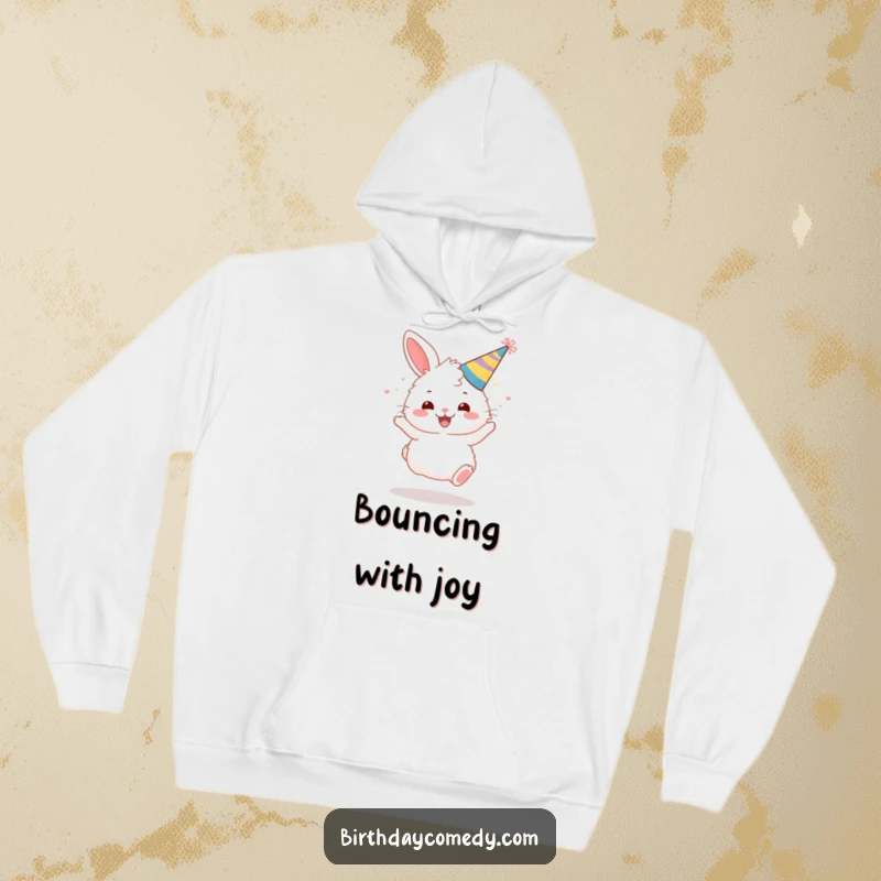 Funny hoodie featuring a fluffy bunny wearing a festive party hat, bouncing with unrestrained joy.