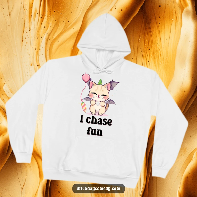 Funny hoodie with a winking cat batting playfully at a dangling party streamer, ideal for fun, cozy wear.