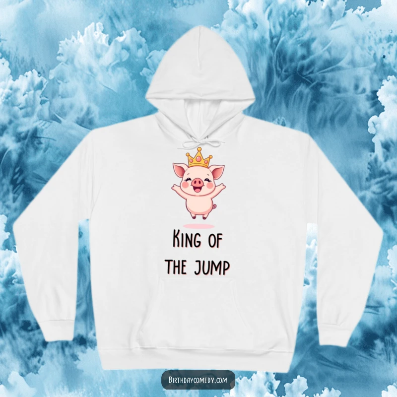 Funny hoodie with a happy piglet wearing a sparkly crown, captured mid-air during a joyful, energetic jump.