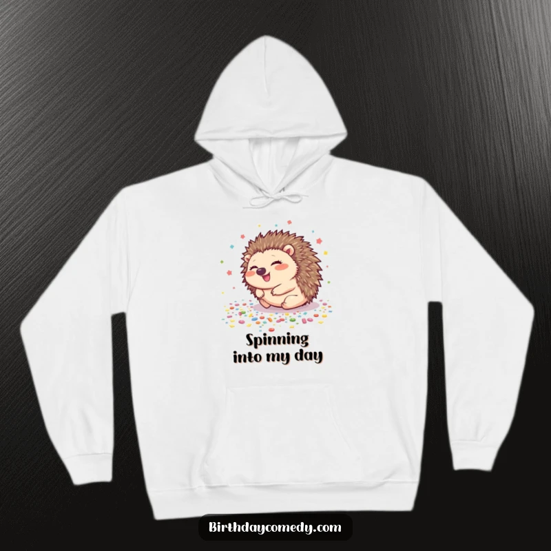 Funny hedgehog hoodie with a giggling hedgehog rolling amidst a shower of confetti, offering warmth and humor.