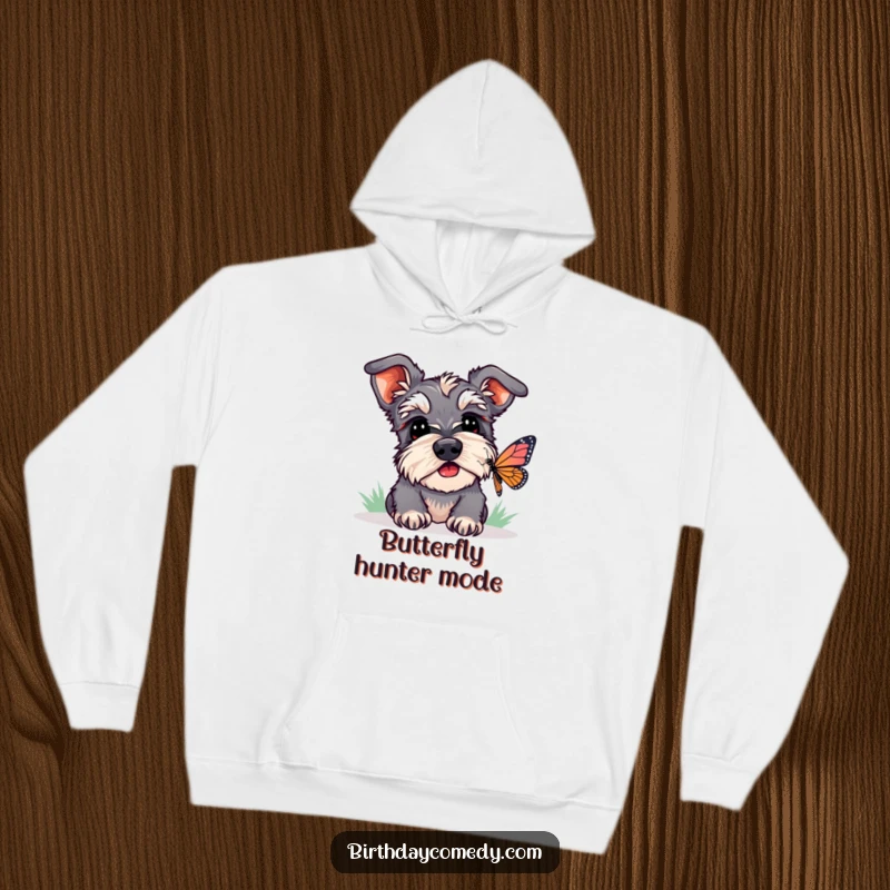 Funny schnauzer hoodie depicting a dog with head tilted, watching a butterfly, evoking curiosity and playful humor.