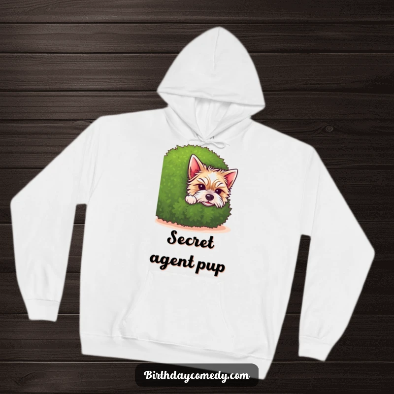 Funny terrier hoodie illustration of a sweet puppy peeking from behind a green shrub, exuding innocence and playful charm.