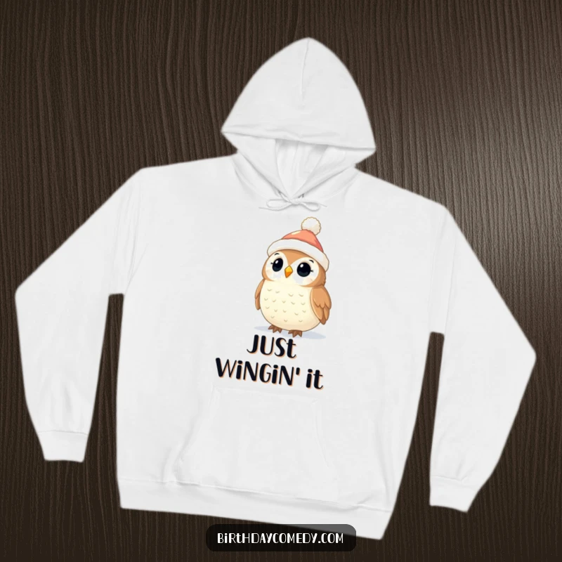 Funny Owl Christmas Hoodie: A cute owl in a tiny stocking cap looks up in wonder at sparkling Christmas lights, embodying holiday joy.