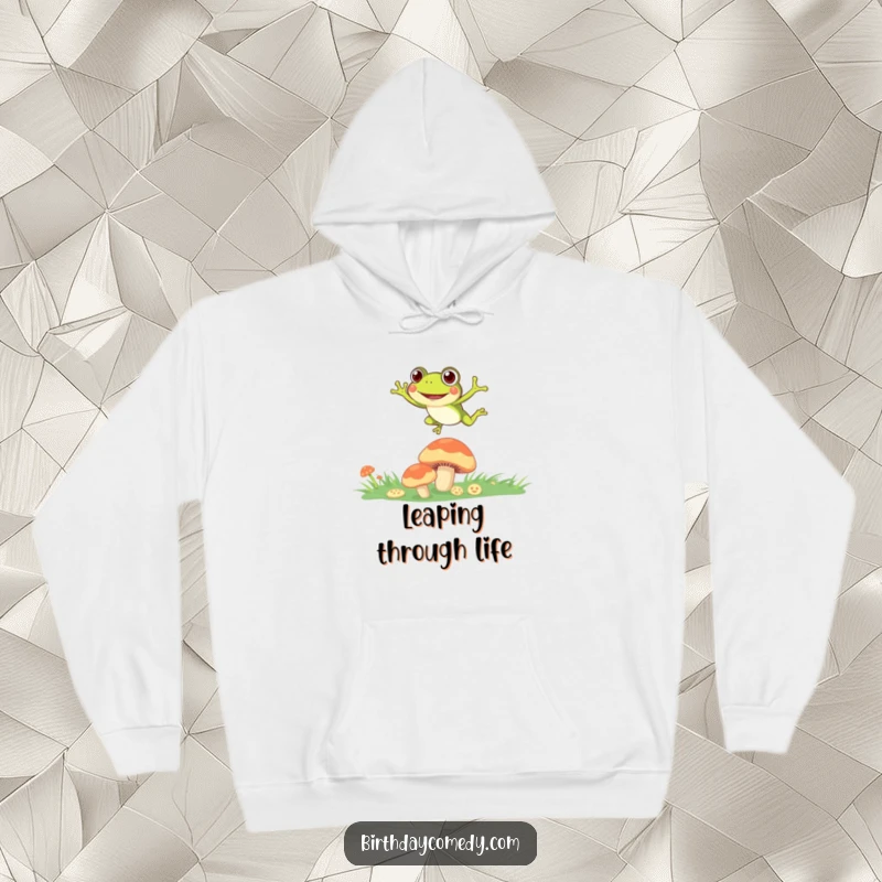 Funny Hoodie showing a joyful frog with wide eyes, leaping between mushrooms, capturing a moment of pure wonder.