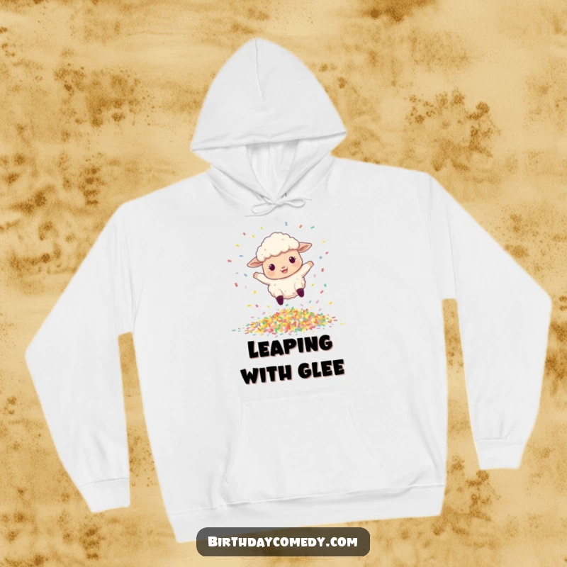 Funny hoodie with a happy, bouncing sheep leaping over a pile of vibrant confetti, perfect for festive wear.