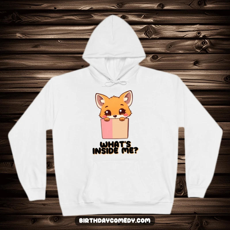Funny Hoodie: A cute, tiny fox with wide, inquisitive eyes peeks out from behind an overflowing gift box, filled with wonder.