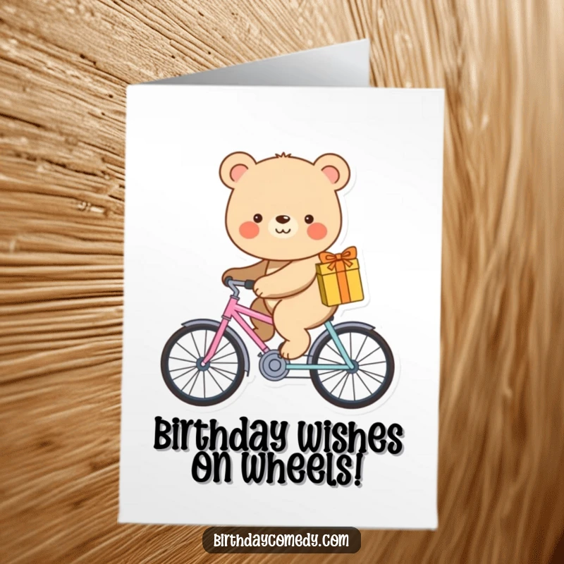 Funny free printable birthday card featuring a smiling bear riding a tiny bicycle while carrying a gift. Joyful delivery.