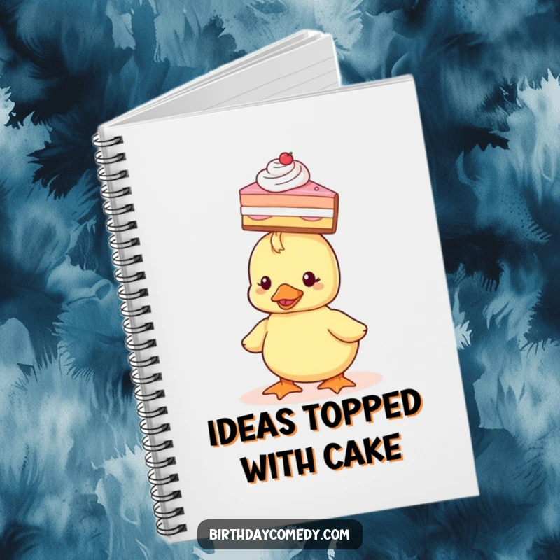 Funny Notebook with a cover showing a tiny duckling balancing a slice of cake on its head, perfect for note-taking.