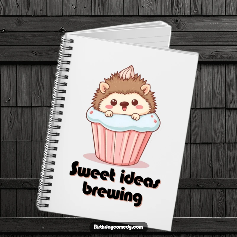 Funny Notebook featuring a cute hedgehog peeking from behind a giant cupcake, perfect for jotting down ideas with a sweet and humorous touch.