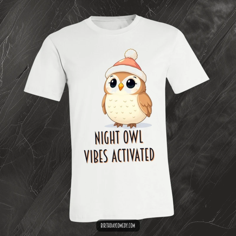 Funny Owl Christmas T-Shirt: A sweet owl sporting a stocking cap is mesmerized by twinkling holiday lights, a joyful sight.
