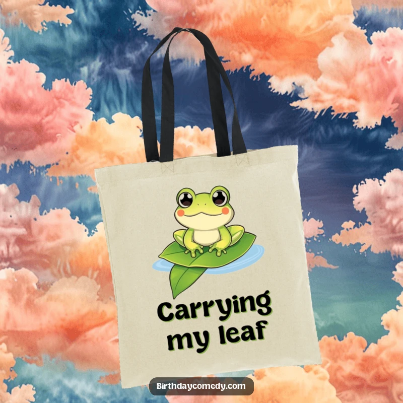 Funny frog tote bag showing a content frog with bulging eyes floating on a large leaf, a humorous carry-all.