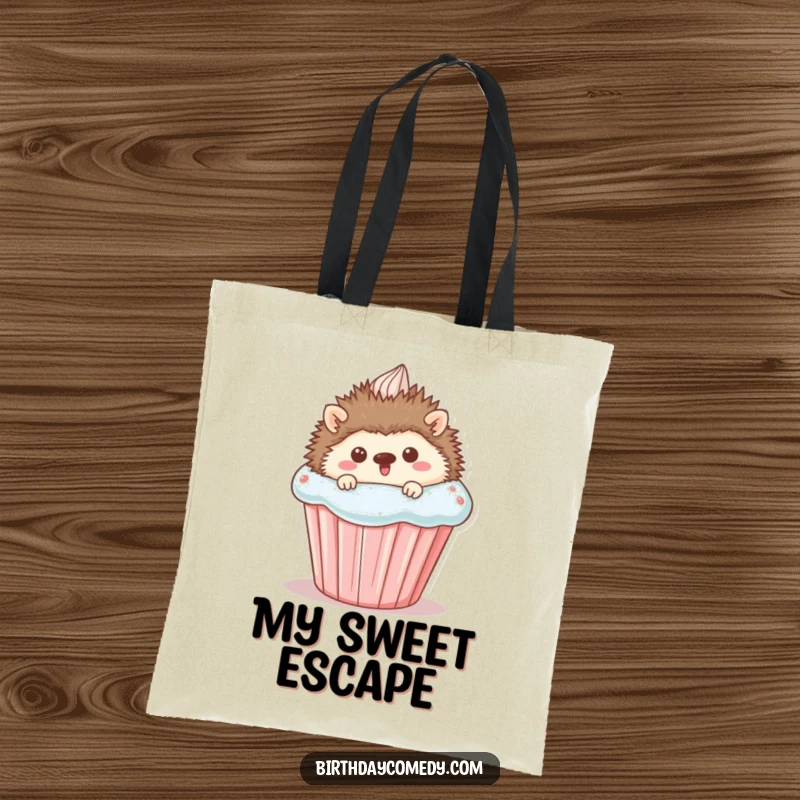 Funny Tote Bag featuring a happy hedgehog peeking from behind a giant cupcake, perfect for carrying essentials with a cute and humorous flair.
