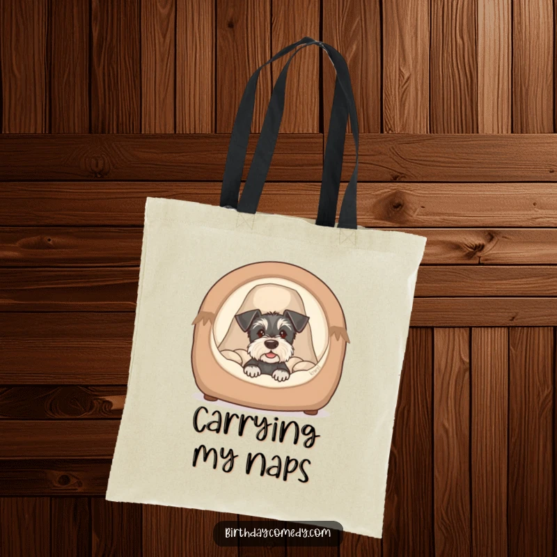 Funny schnauzer puppy tote bag featuring a cute dog peeking from a cozy bed, a humorous and charming accessory.