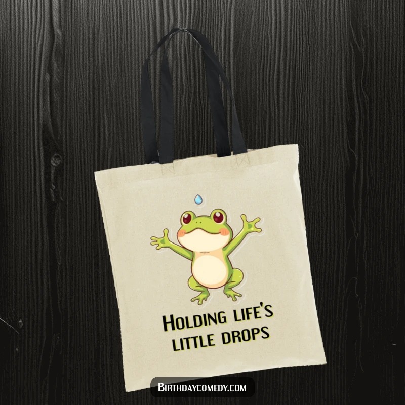 Funny frog tote bag showing a cute frog with arms wide, catching a falling dewdrop, perfect for carrying items humorously.